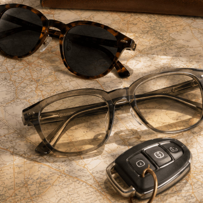 Tortoise sunglasses with a clear pair of frames on a folded map